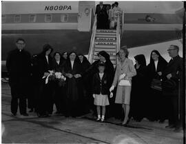 Group of nuns meet Vicar General Salesians at steps of Pan American Airlines (PAA) jet