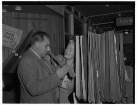 Miss Gracie Fields visiting Shannon Airport, pictured at the Irish tweed counter with a man