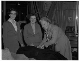 Miss Gracie Fields visiting Shannon Airport, pictured at the Irish tweed counter with two women