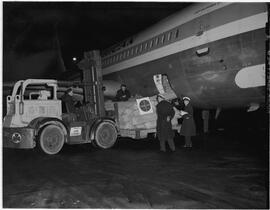 Two men loading freight onto Pan American Airlines (PAA)