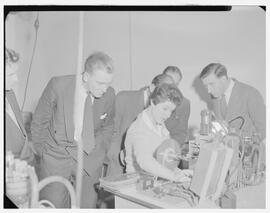 SPS factory tour - Men watch woman work