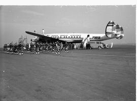 Pipers on St. Patrick's Day on tarmac, near aeroplane