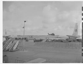 Planes on ramp with helicopter