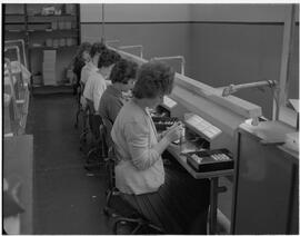 Industrial components - Four girls at bench