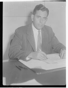 J.G. Ryan at desk