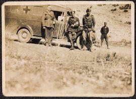 Photograph of a group of Irish Brigadiers beside a vehicle