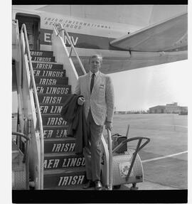Man on steps of plane
